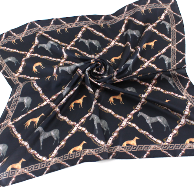 Black square scarf with horses, hounds, and a rope-like lattice pattern in warm gold and neutral tones.
