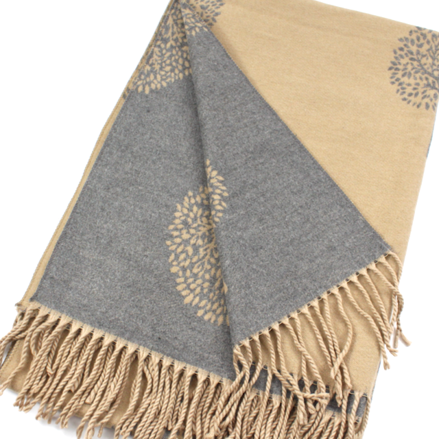 Khaki and gray reversible scarf folded to show contrasting tree motifs on both sides, with khaki fringe at the ends.
