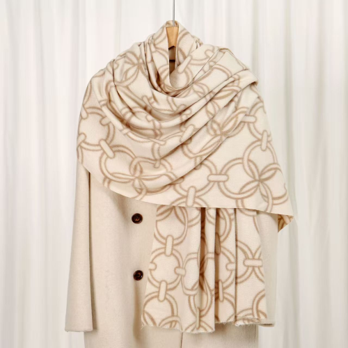 Beige and ivory chain print scarf with an allover interlocking link pattern draped on a neutral background