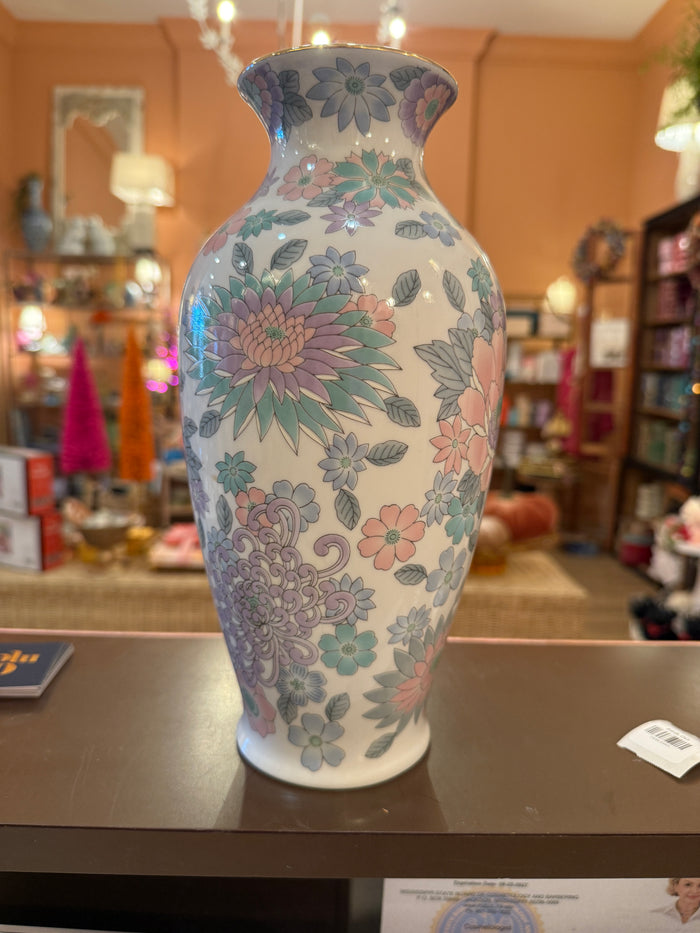 Reverse view of floral porcelain vase showing a large blush pink bloom and smaller pastel flowers.
