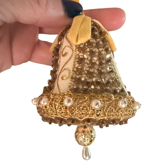 Vintage gold and ivory bell ornament with sequins, pearl-look trim, a yellow ribbon loop, and a dangling teardrop.