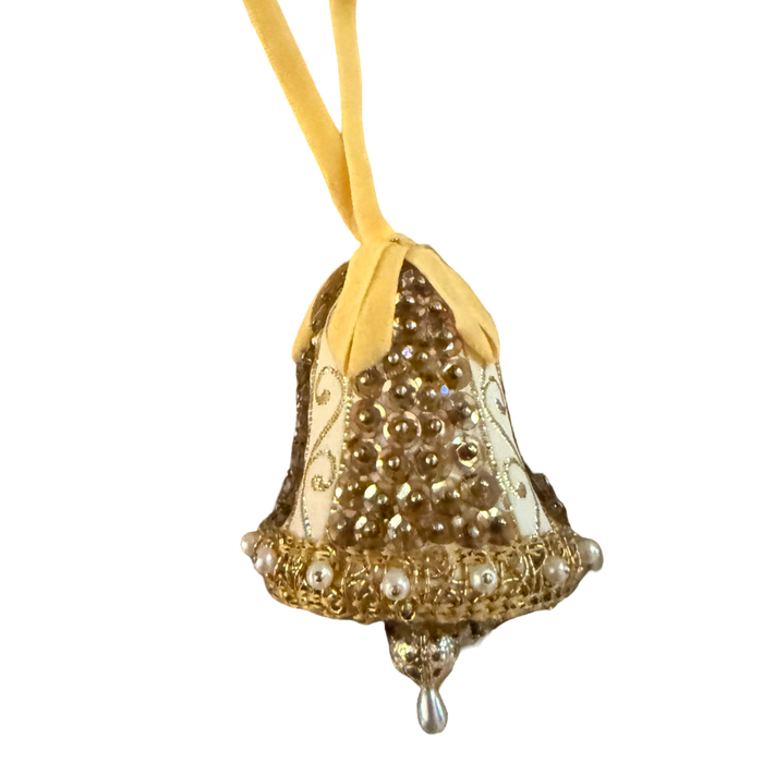 Vintage gold and ivory bell ornament with sequins, pearl-look trim, a yellow ribbon loop, and a dangling teardrop.