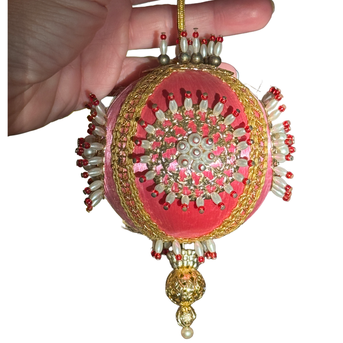 Vintage pink satin-thread ornament with gold-tone medallions, pearl-look beads tipped in red, metallic braid, and an ornate gold-tone drop.