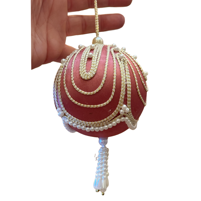 beautiful vintage pink satin Christmas ornament with cascading gold trim, faux pearl embellishments, and a decorative beaded tasse